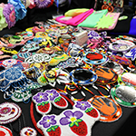 Several colourful beaded earrings and effigies.