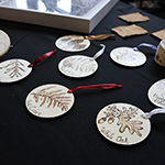 A set of 8 pyrographed Christmas ornaments.