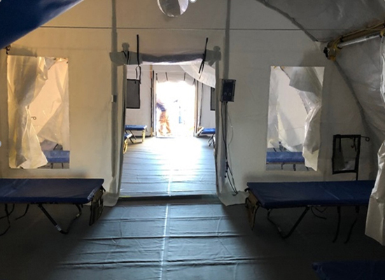 Photo of a negative pressure isolation section of mobile health structure, with beds.